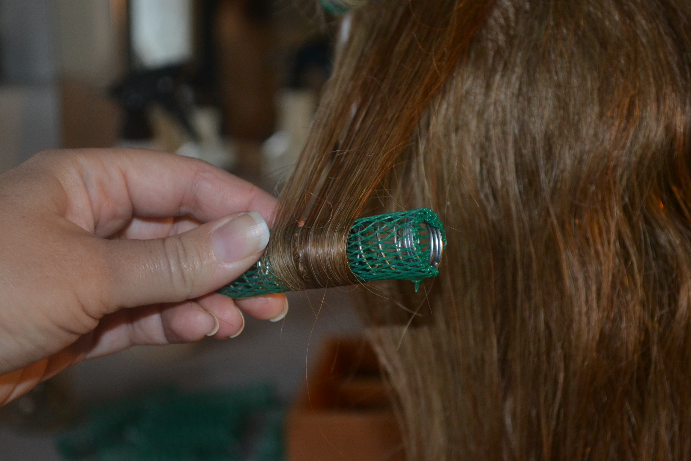 putting a roller in a section of hair
