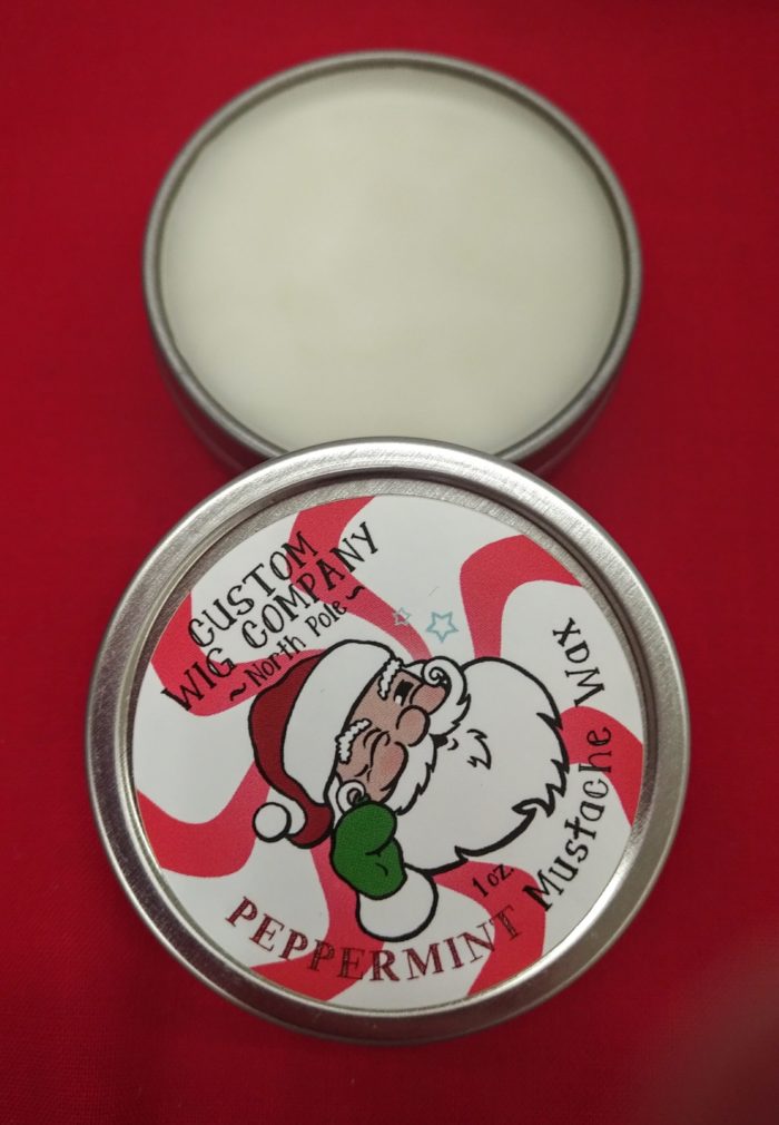 Light peppermint mustache wax in a tin